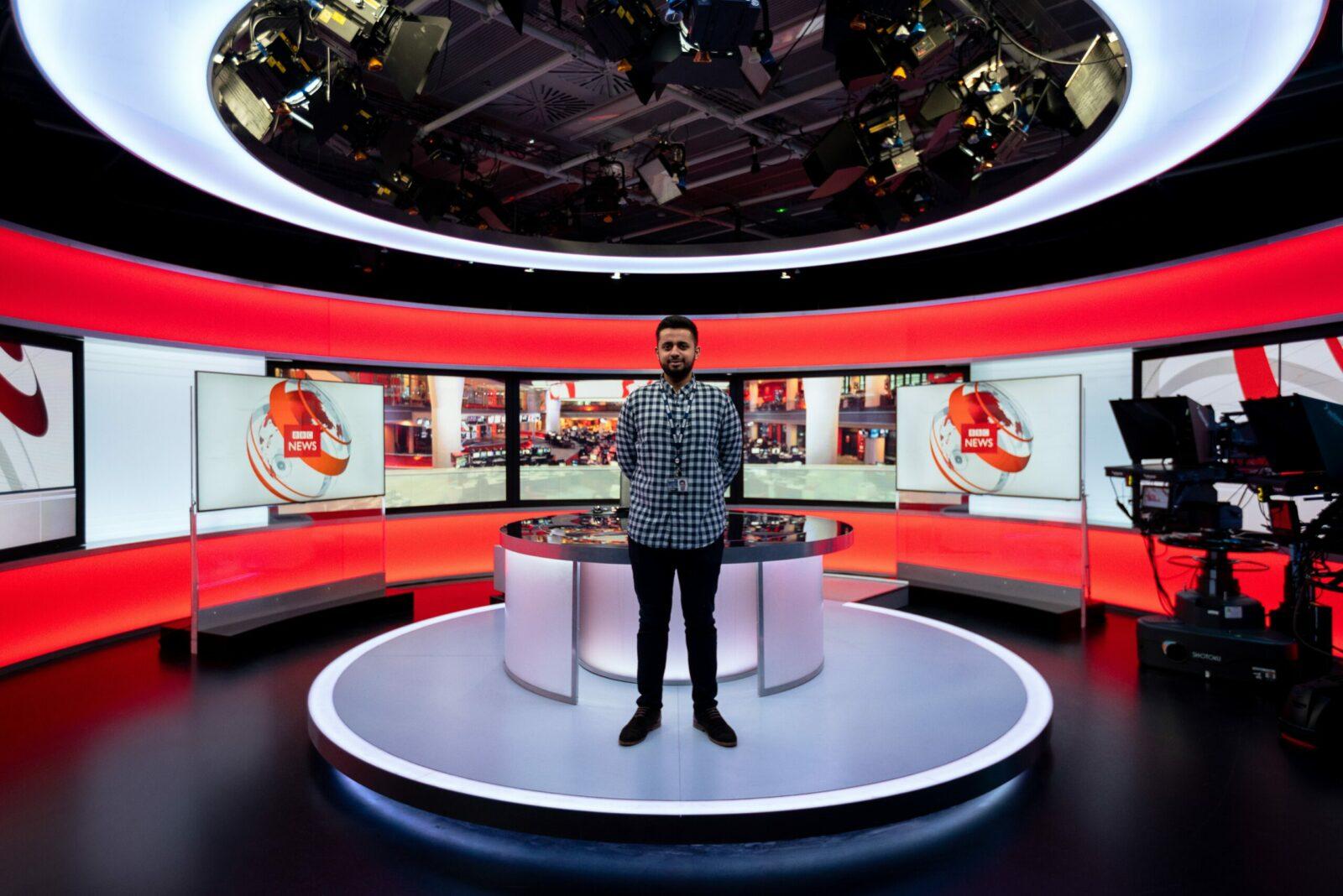 Man standing in a TV new studio