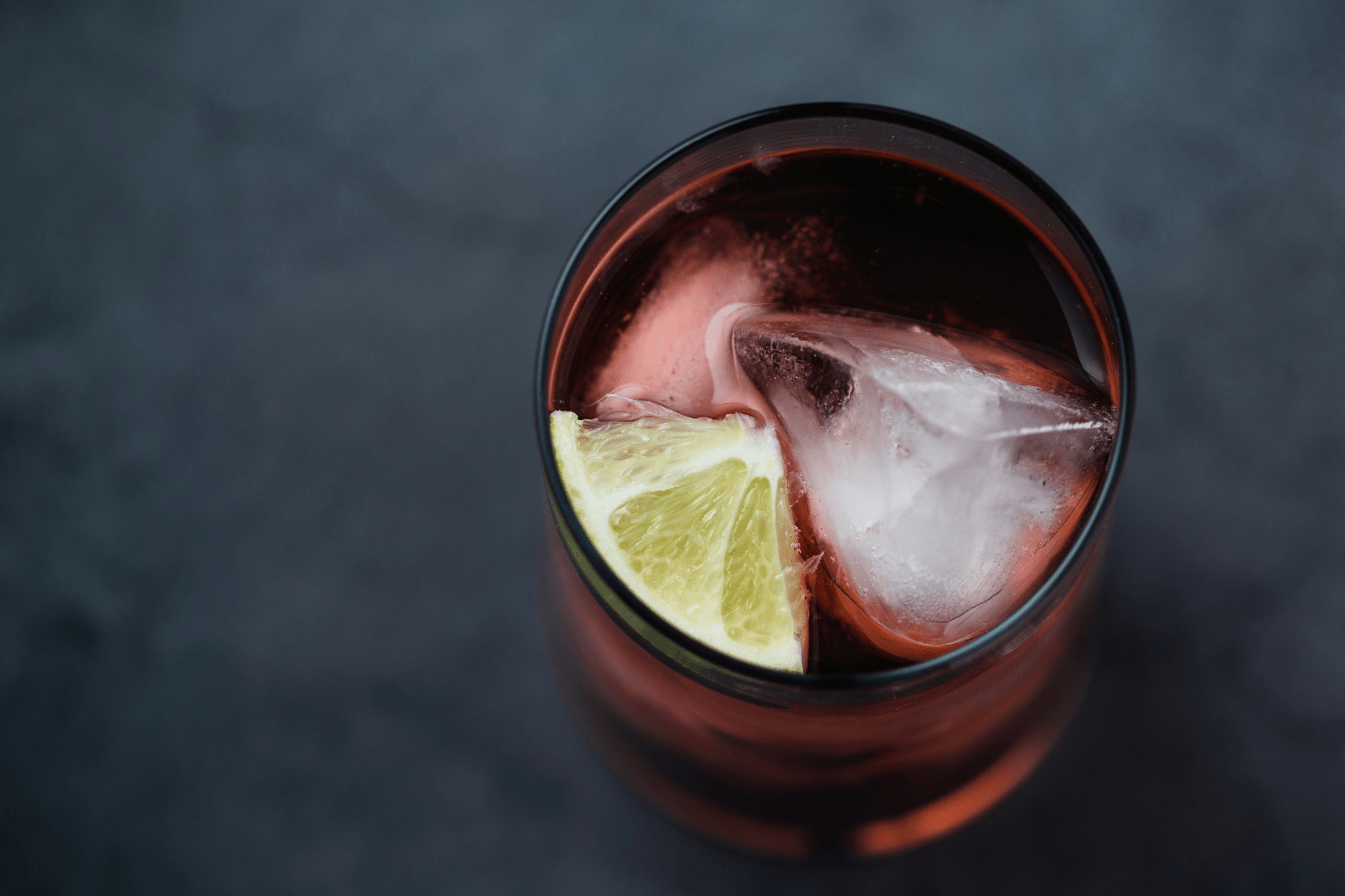 Cranberry Juice with ice and lemon viewed from above